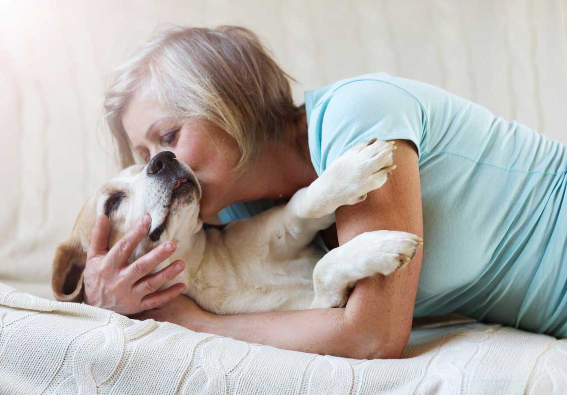 Woman with her dog protected by heartworm prevention in Lubbock, TX